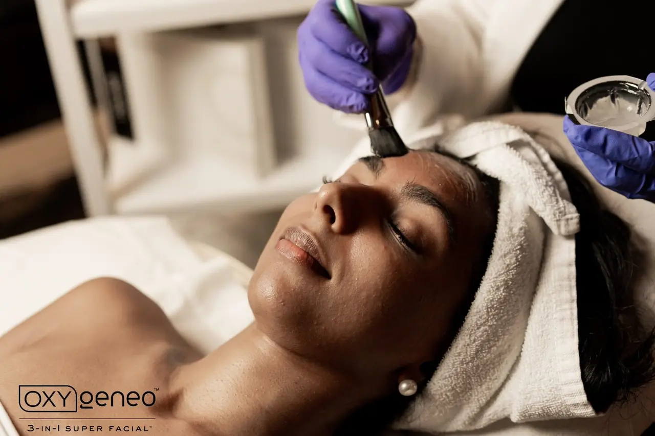 A practitioner applying treatment gel during an OxyGeneo facial
