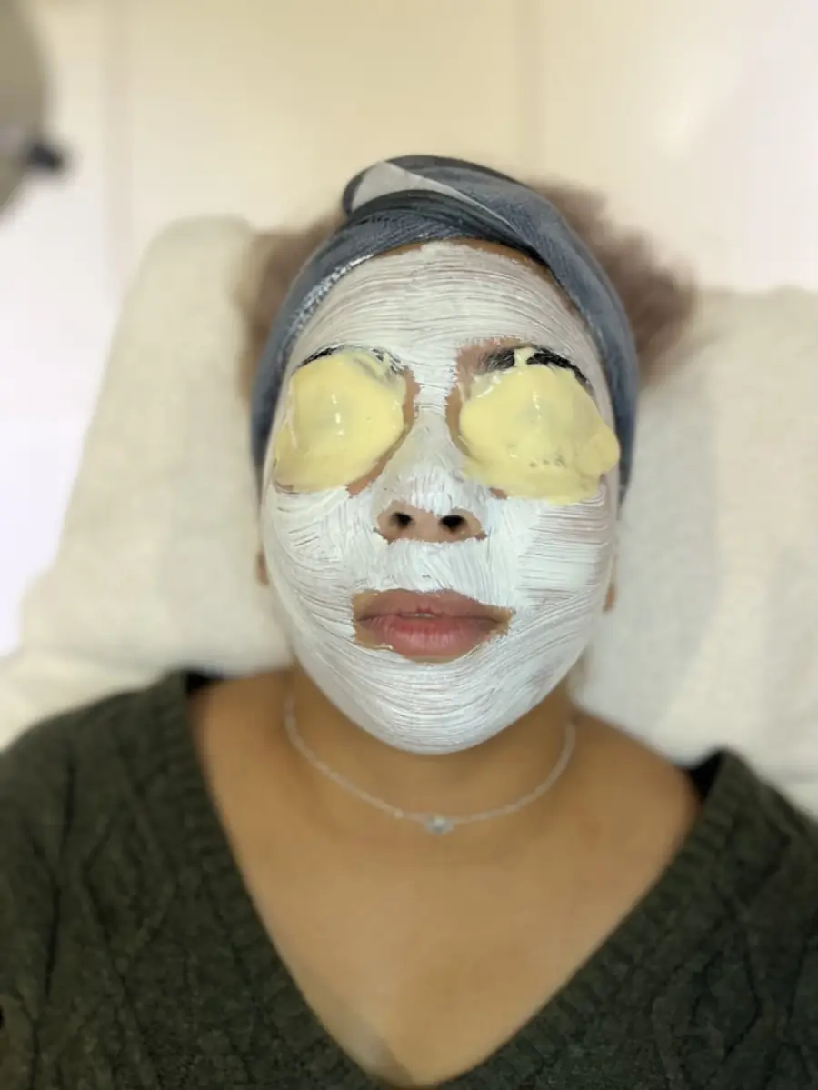 A client wearing a calming mask and eye pads