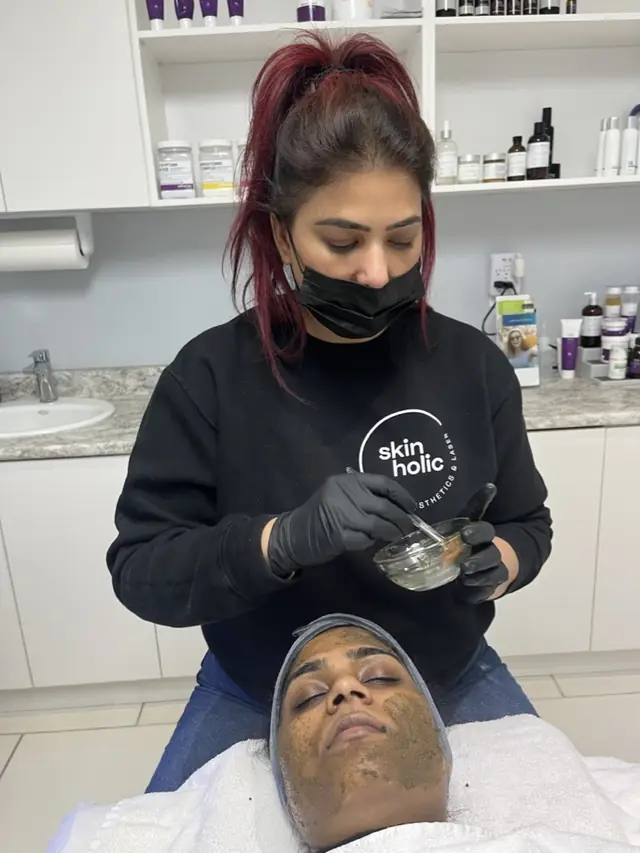 A practitioner mixing a professional peel